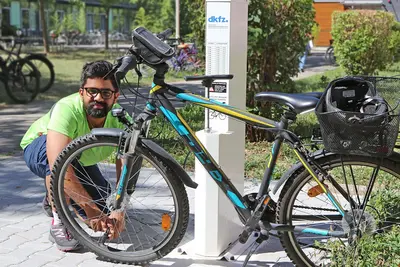 Mann füllt Fahrradreifen in einer Fahrradreparaturwerkstatt