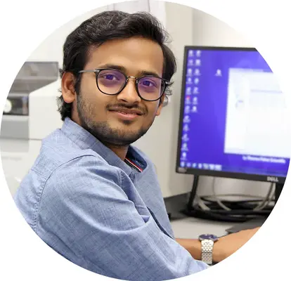 Subhayan sitting in front of a computer screen.