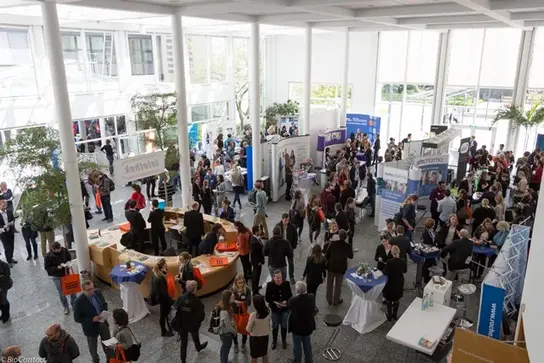 DKFZ communication center lobby with people attending the BioContact job fair.